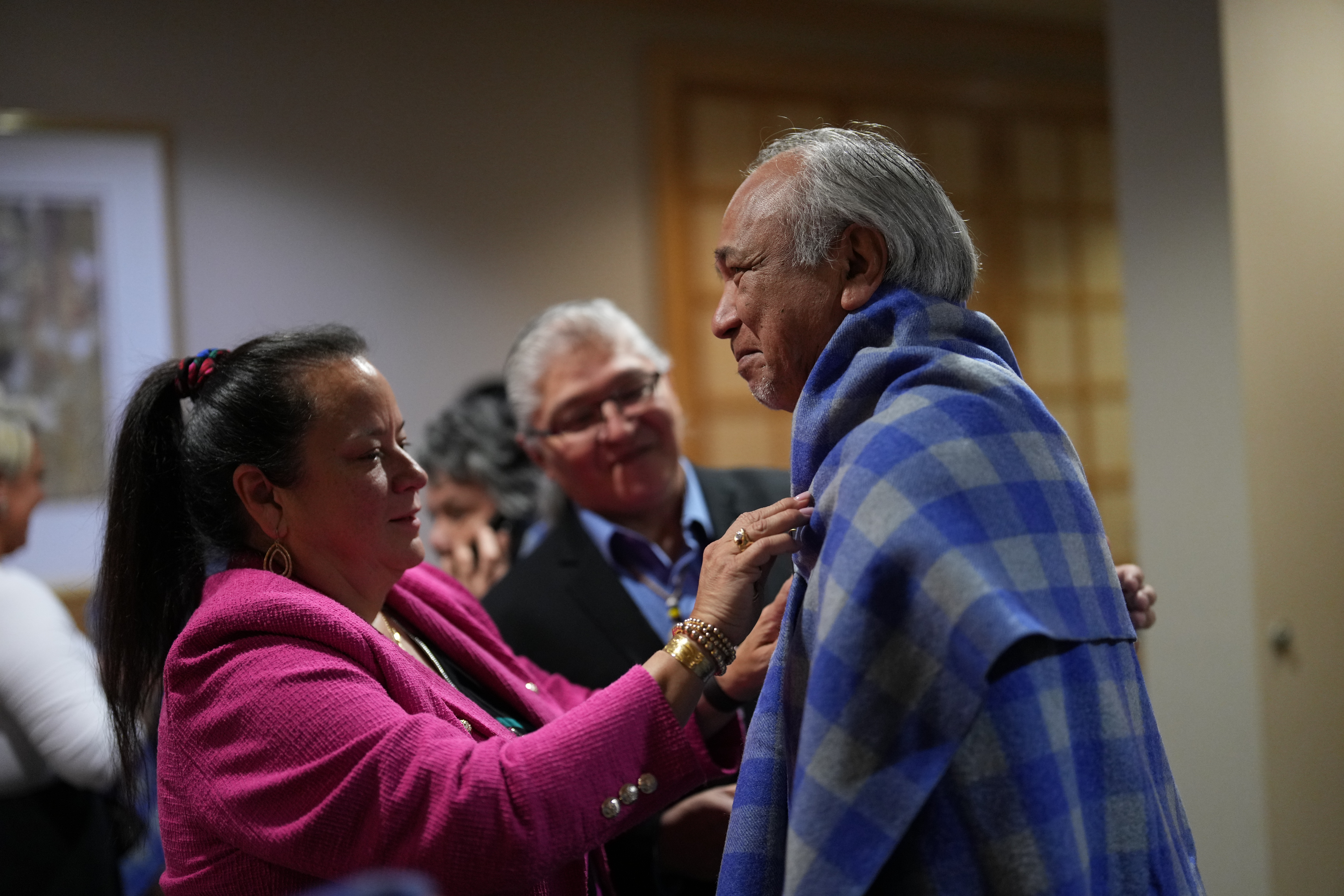 BCFNJC Chair, Kory Wilson and Council Member, Clifford White, blanket Grand Chief Steven Point during the Honouring Ceremony & Feast during the 3rd Annual Justice Forum
